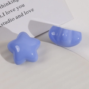 Close-up of glossy light purple resin star and heart-shaped DIY craft hair accessories