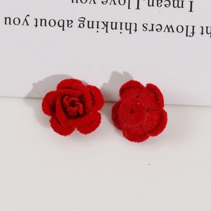 Detail of red flocked rose charms for DIY jewelry making with velvety texture