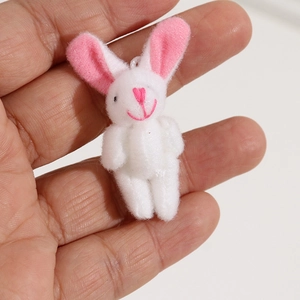 Cute white plush bunny keychain with pink ears held in hand for size display