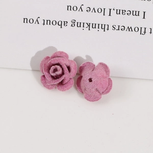 Macro view of pink flocked velvet rose charms with center holes for DIY jewelry making