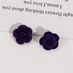 Macro shot of dark purple flocked rose earrings with velvet texture for DIY accessories