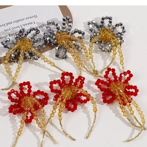 Detailed view of handmade beaded flower charms with beaded fringe for jewelry making