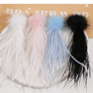 Close-up of colorful feather tassels and soft fur balls for DIY jewelry accessories