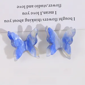 Detailed view of blue marble acetate butterfly clips set for DIY hair accessories
