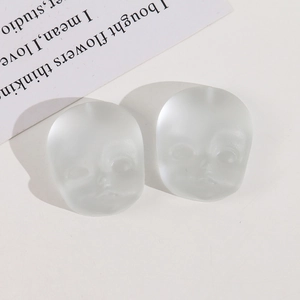 Macro view of matte translucent resin baby face charms for DIY jewelry accessories