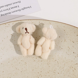 Close-up of cute plush cream teddy bear charms with soft texture for DIY jewelry