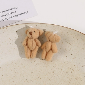 Macro shot of two mini khaki plush teddy bears on a ceramic tray for DIY projects