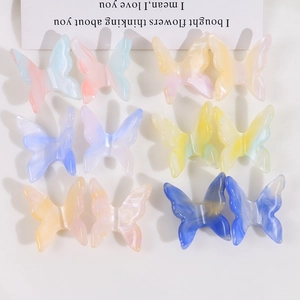 Detailed flat lay of gradient marble resin butterfly accessories for DIY jewelry and hair clips