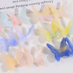 Detailed macro view of 3D gradient resin butterfly charms for DIY hair clips and phone cases