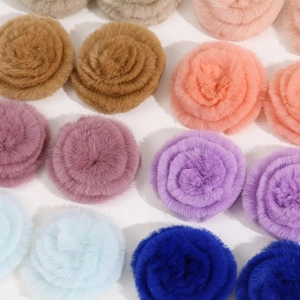 Flat lay of colorful 4cm plush rabbit fur rose flower charms for DIY hair accessories