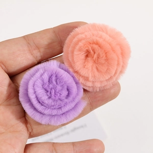 Macro shot of 4cm soft rabbit fur flower hair clips in purple and coral pink hues