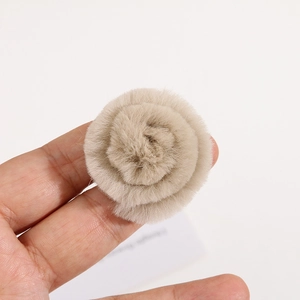 Macro detail of 4cm light camel rabbit fur flower accessory with soft fluffy texture