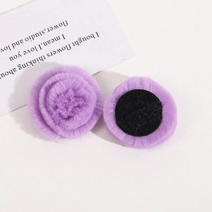 Close-up of lavender faux fur rose flower accessories with a black felt base for DIY