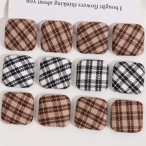 Detail view of square fabric checkered buttons with texture for DIY jewelry making