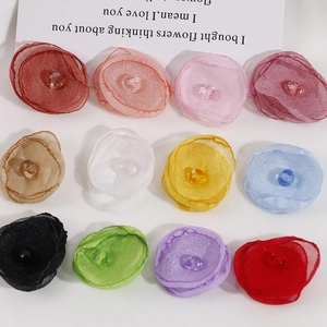 Macro detail of handmade colorful sheer organza flowers with faceted crystal beads