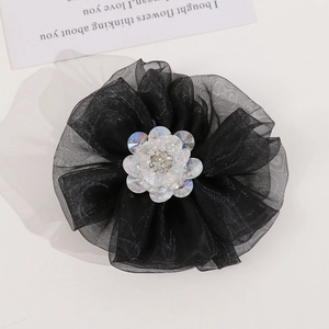 Detail of multi-layered black organza mesh flower with crystal center and sparkling rhinestone