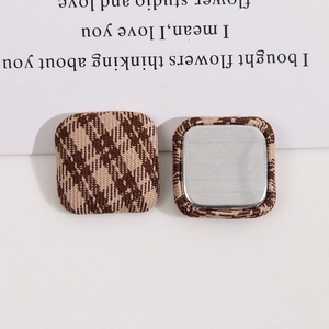 Detail showing front and back of square brown checkered fabric metal buttons for DIY