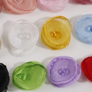 Macro view of colorful organza handmade flowers with faceted crystal beads for DIY crafts