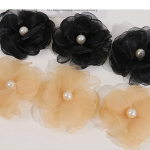 Detailed view of layered mesh flower hair clips with central faux pearl embellishment