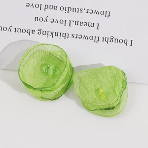 Close-up of handmade green tulle flower accessories with crystal bead for DIY crafts