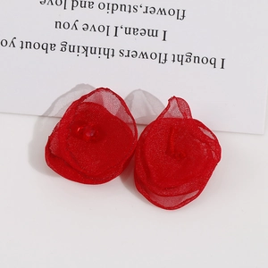 Detailed macro view of handmade red mesh flower ornaments with central bright bead accents