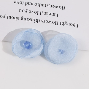 Close-up of handmade light blue sheer mesh flower petals for DIY earrings and hair jewelry