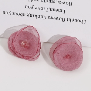 Detailed close-up of handmade 3D mesh flower accessory in dusty rose pink color