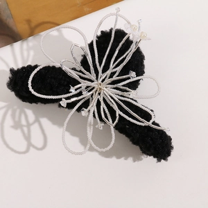 Black plush hair claw clip with handmade white floral beadwork and pearl accents