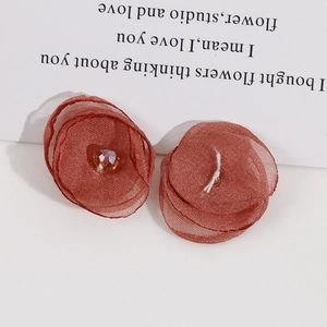 Detail of DIY handcrafted brown chiffon fabric flower with multifaceted crystal bead center