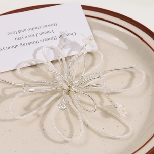 Detailed view of handcrafted white beaded flower hair clip with glass petals and pearls