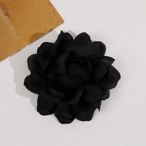 Close-up of black multilayer satin camellia flower for DIY hair or clothing accessories