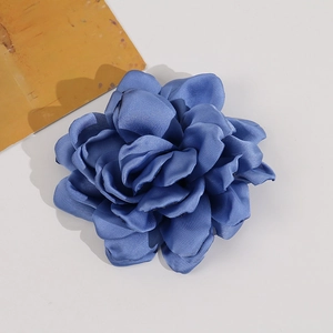 Macro view of multi-layered navy blue fabric camellia flower accessory for DIY fashion