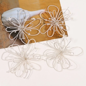 Set of four handmade white beaded flower charms for hair accessories and DIY crafts
