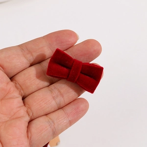 Close-up of a handmade red velvet bow accessory for DIY hair clips and decorations