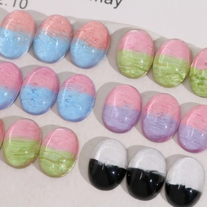 Close-up of oval mixed-color resin cabochons with marble texture for DIY jewelry making
