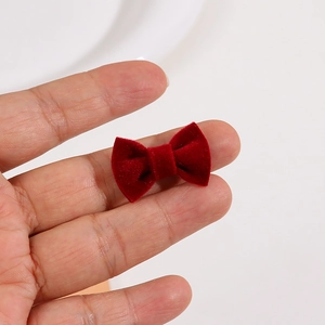 Close-up of a mini red velvet bow showing the soft flocking texture for DIY hair accessories