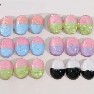 Macro detail of colorful oval resin cabochons with gradient sand texture for DIY jewelry