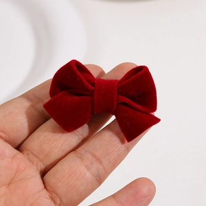 Macro detail of high-quality red velvet bow with soft flocking texture and classic symmetry