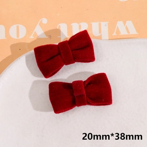 Close-up of handmade velvet burgundy bow hair clips with soft plush texture details