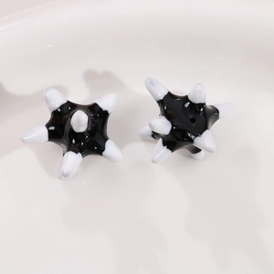 Close-up of black star-shaped sea urchin ceramic beads with white tips for jewelry