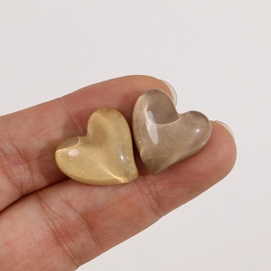 Macro shot of heart-shaped resin charms with pearlescent finish for DIY jewelry
