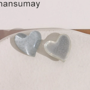 Close-up of marble blue and translucent white resin heart charms for DIY jewelry making