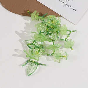 Macro detail of handmade green beaded flower cluster with translucent resin petals