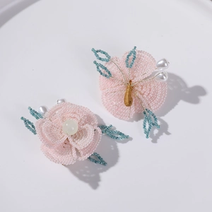 Detalle de flor de cuentas hecha a mano con perlas rosas y verdes para accesorios de pelo