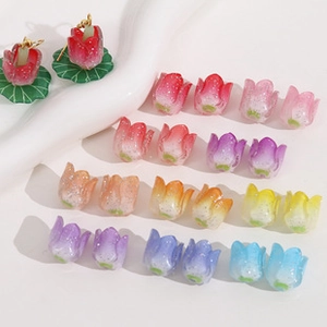 Macro detail of tulip flower bud acrylic charms with glitter finish for DIY jewelry making