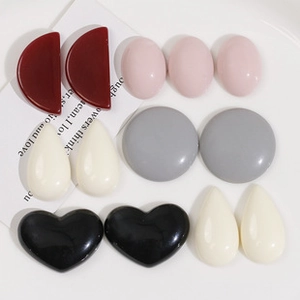 Close-up of heart-shaped and geometric colorful resin charms with smooth mirror finish