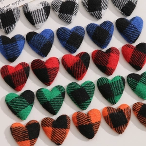 Detailed grid of colorful buffalo plaid heart fabric patches for DIY craft accessories
