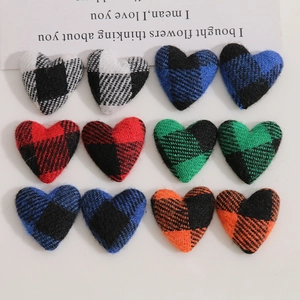 Detailed view of checkered heart fabric patches for DIY jewelry in multiple colors