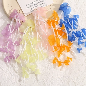 Detailed view of colorful acrylic flower beaded tassels for DIY floral earrings