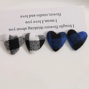 Detailed view of heart-shaped checkered fabric patches for DIY craft accessories